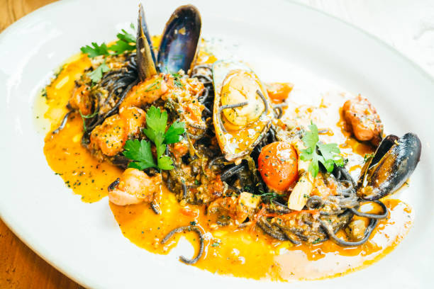 istock Black spaghetti and pasta with mussel and squid 814382592