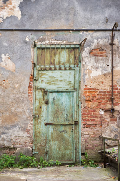 istock grunge metal door, cracked brick wall 814387190