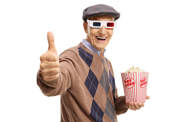 istock Senior with 3D glasses and popcorn making thumb up sign 814387462