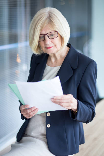 istock Confident senior businesswoman reading papers 814390502