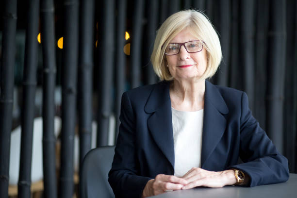 istock Positive senior female executive sitting in office 814390684