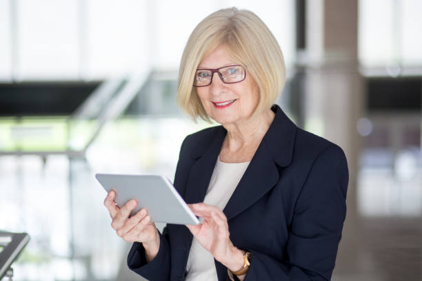 istock Successful senior businesswoman using touchpad 814390748