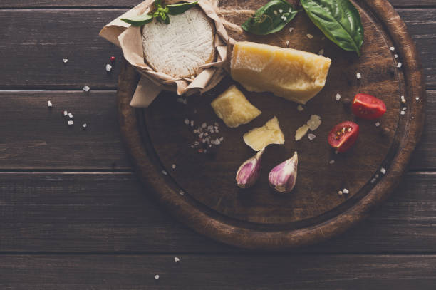 istock Cheese delikatessen closeup on rustic wood, brie and parmesan 814402036
