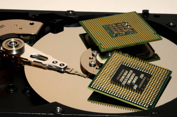 istock close up of opened hard disk with two CPU processors over. technology background. abstract. 814405124