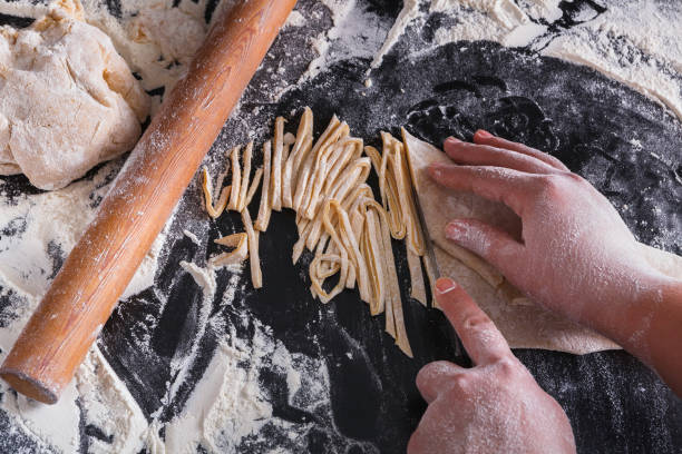istock Cooking noodles concept on black background, sprinkled flour with copy space 814408500
