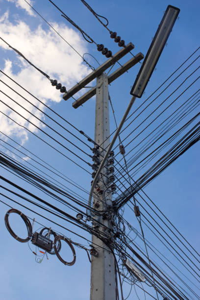 istock chaotic wire with nest on pole and blue sky background 814421256