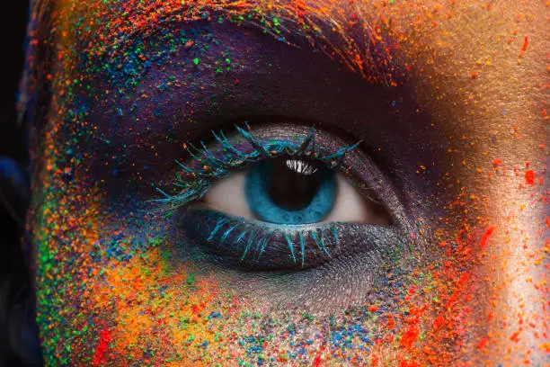 Photo of Eye of model with colorful art make-up, close-up