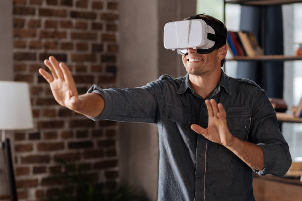istock Curious emotional man enjoying futuristic experience 814447014