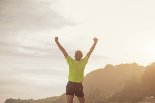 istock Success of a man after jogging / exercising on a clif. 814449848