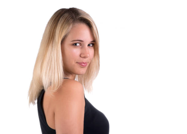 istock Attractive young woman looks at the camera over her shoulder 814450024