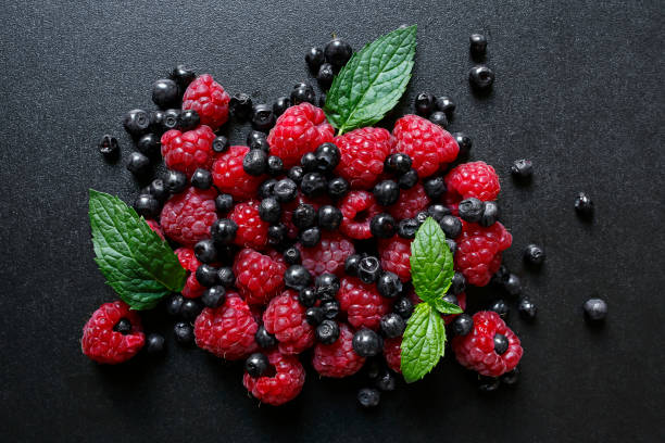 istock fresh summer fruits on black background 814453400