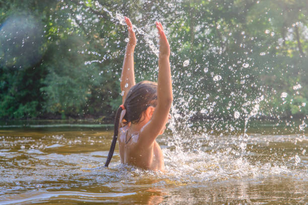 istock Girl bathes in the river in summer. 814458964