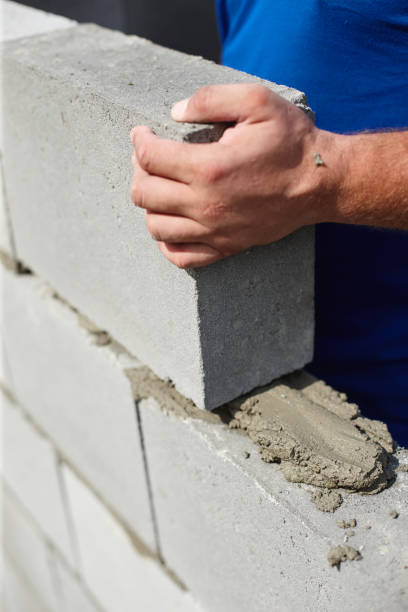 istock Close up of industrial bricklayer installing bricks on construction site 814469046