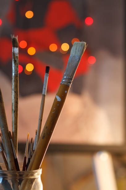 istock Artistic brushes in the workshop. Brushes artist on an abstract blurred background in the studio for artists. 814490626