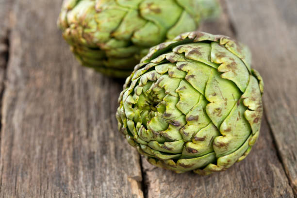istock artichokes on wooden table 814491198