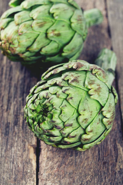 istock artichokes on wooden table 814491204