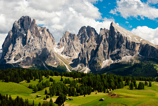 Aerial view of Italian alps Dolomites, surrounded by green meadows - Puez Geisler Nature Park.