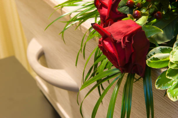 Coffin in morgue A coffin with a flower arrangement in a morgue coffin crematorium stock pictures, royalty-free photos & images