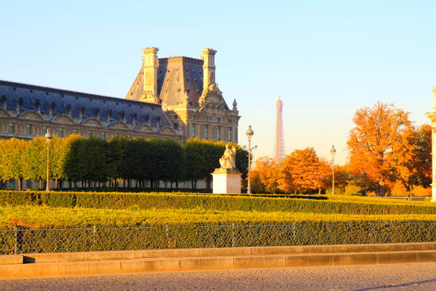 istock Paris idyllic Urban Skyline: majestic Eiffel Tower at dramatic gold colored Sky sunrise from Tuileries gardens, Paris cityscape, France 814497012
