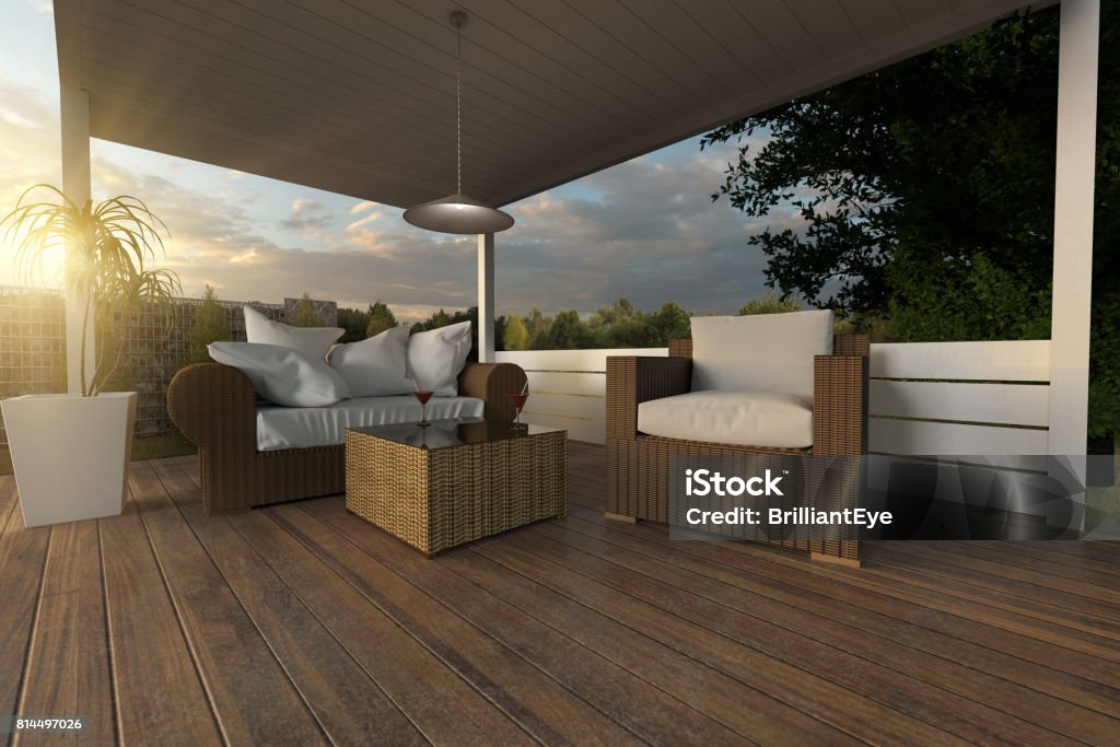 3d rendering of rattan garden furniture on wooden patio at garden in the evening sunshine Patio Stock Photo