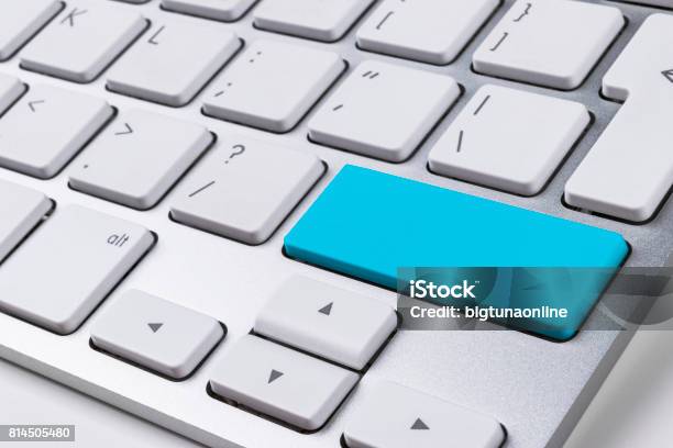 Close Up View Of A Computer Notebook Keyboard With One Blue Button On Office White Table Technology Background Empty Space For Text Stock Photo - Download Image Now