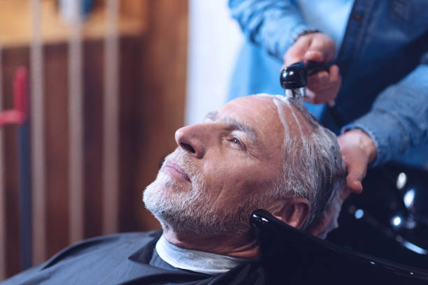 istock Delighted elderly man having his hair washed 814506088
