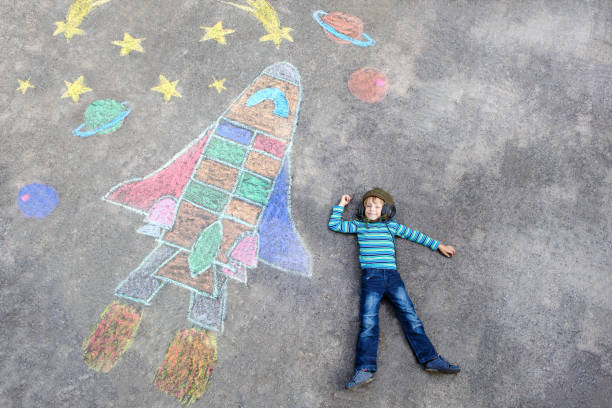 istock little kid boy flying by a space shuttle chalks picture 814515410