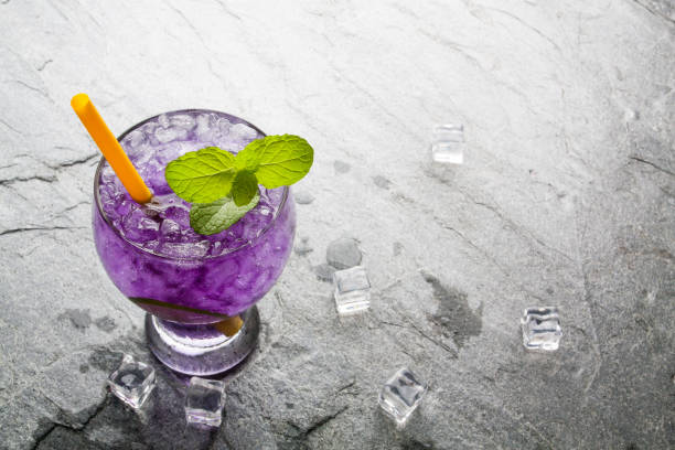 istock Purple soda lime drink with lime on stone. 814531788