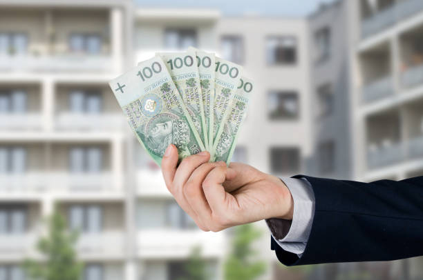 istock Real estate agent holds Polish money 814531858