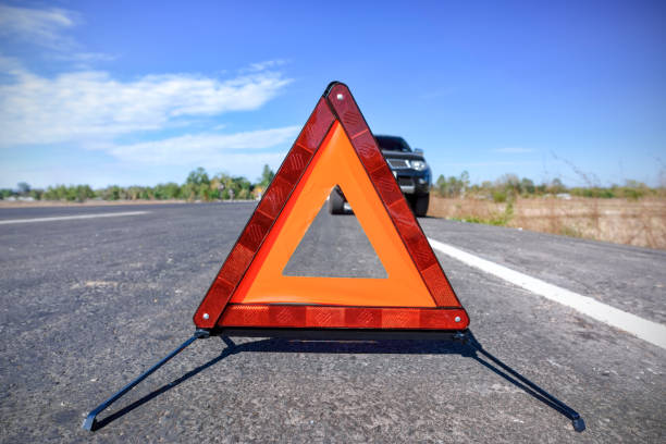istock Red emergency stop sign and broken car on the road 814532242