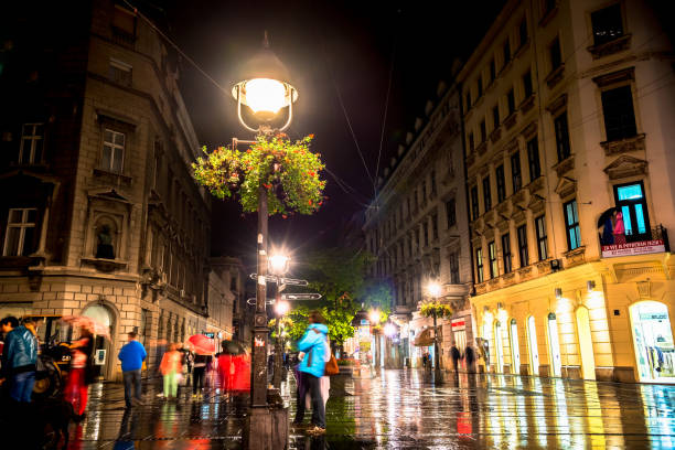 Rainy inght at Knez Mihailova Street on September 25, 2015 in Belgrade, Serbia. Street is the main shopping mile of Belgrade Belgrade: Rainy inght at Knez Mihailova Street on September 25, 2015 in Belgrade, Serbia. Street is the main shopping mile of Belgrade knez mihailova stock pictures, royalty-free photos & images