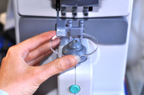 istock Female optician measuring and preparing glasses 814540976