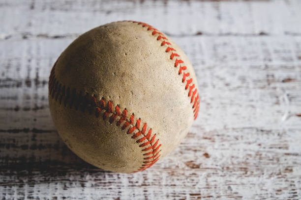 istock old Baseball and glove on wood background with filter effect retro vintage style 814540994