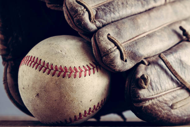 istock old Baseball and glove on wood background with filter effect retro vintage style 814541090