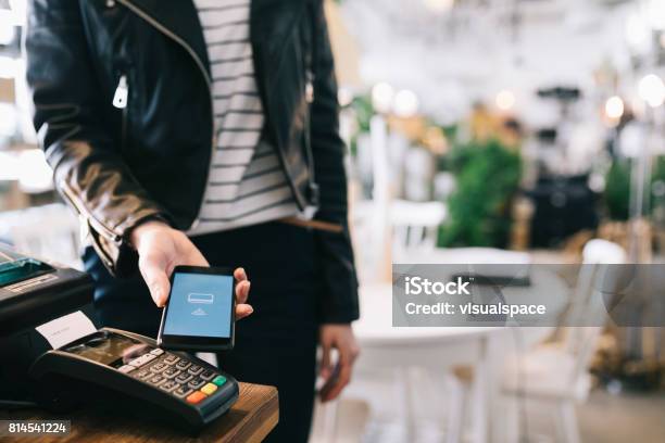 Woman Paying With Smartphone Stock Photo - Download Image Now - Paying, Mobile Phone, Banking