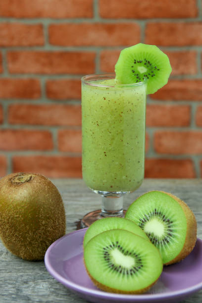 istock Fresh  smoothie kiwi in glass on rustic wood  background. 814563536