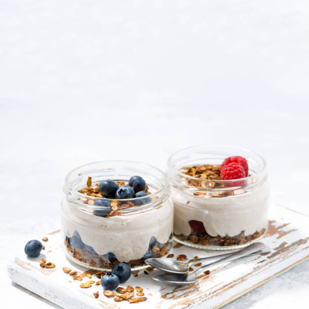 istock healthy creamy dessert with berries and white background 814564418