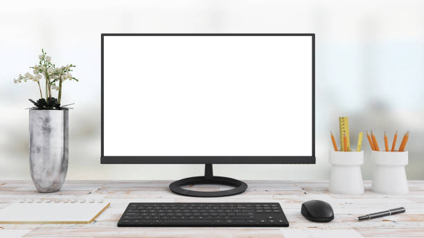 Computer monitor on an office desk with equipment stock photo