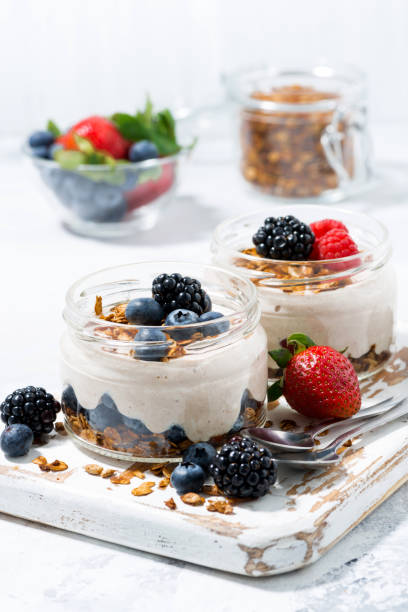 istock healthy creamy dessert with fresh berries on white board, vertical 814564516