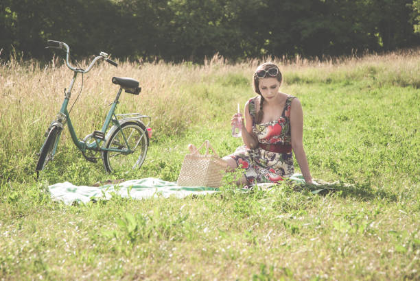 istock Young Woman Relaxing and Reading on the Meadow 814564702