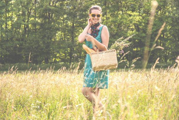 istock Smiling Young Woman Walking Along the Meadow 814564768