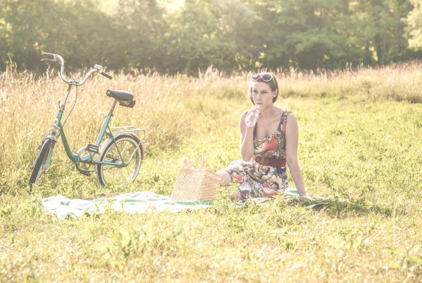 istock Young Woman Relaxing and Reading on the Meadow 814564780
