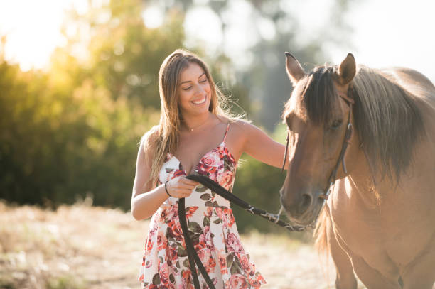 istock A Women Walking Her Horse In A Field 814571372