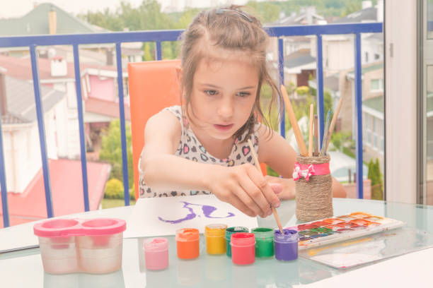 istock Children's drawing water color paints. The child draws. 814572152