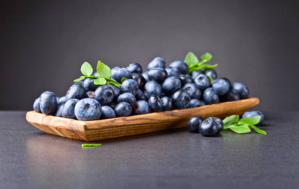 istock Blueberries in old wooden dish . 814577008