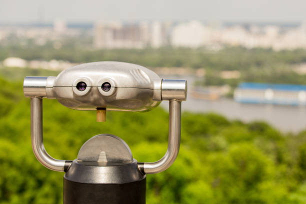 istock Stationary observation binoculars , metropolis landscape on the background with bridge, river, boats,  subway, and skyscrapers 814578548