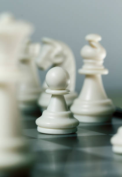 istock Chess figure pawn on board. Chess game play closeup. Chess figures with focus on pawn. 814580954