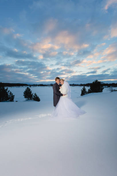 istock Bride and groom and winter lanscape 814587634