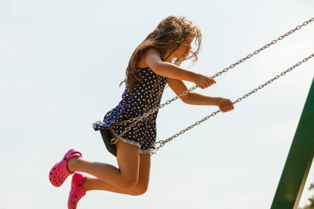 istock Girl swinging on swing-set. 814587988