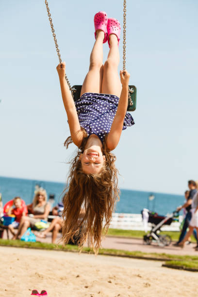 istock Playful crazy girl on swing. 814593492